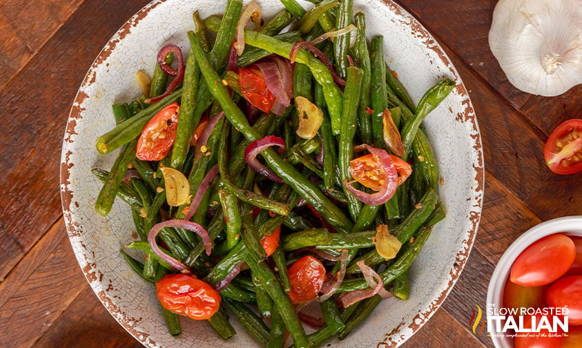bowl of green beans with garlic and roasted tomatoes.