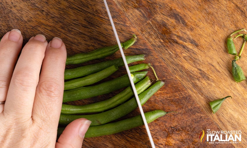 knife trimming ends from Italian green beans.