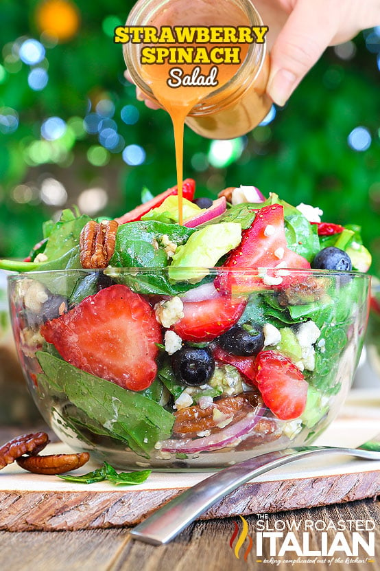 spinach strawberry salad in a clear bowl