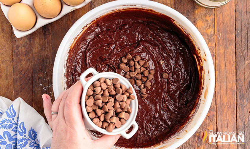 caramel fudge brownies batter adding chocolate chips