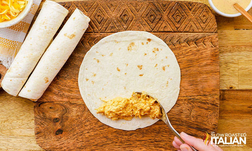 assembling shredded chicken taquitos