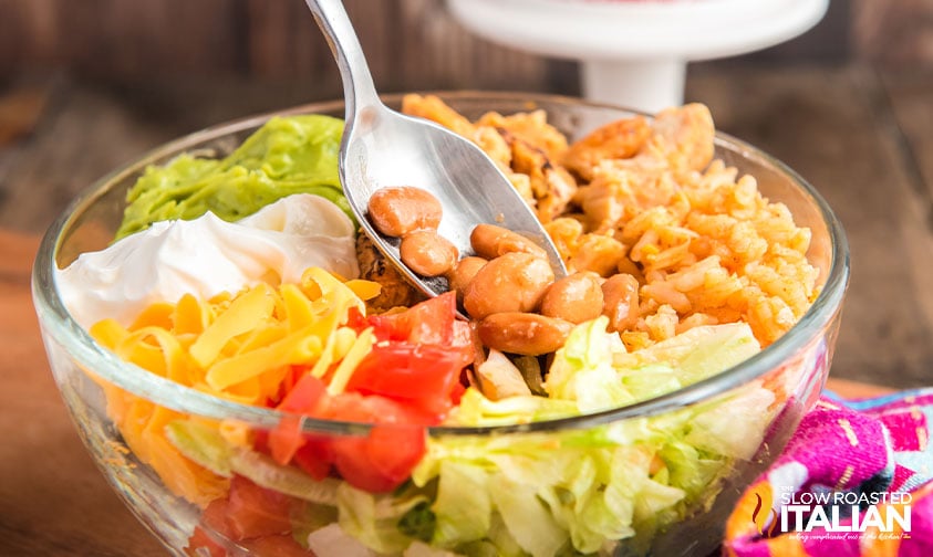 adding chipotle pinto beans to a salad
