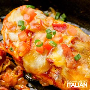 tomatoes, sliced green onions and melted cheese on chicken breast