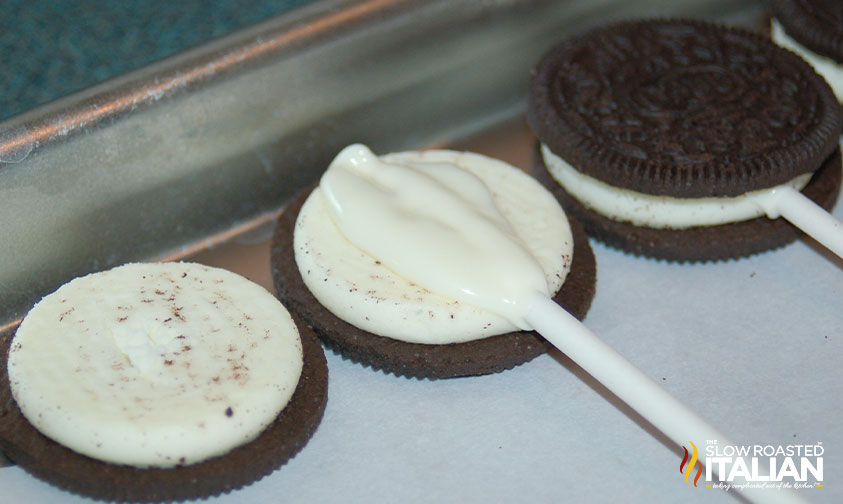 lollipop stick in center of cream of chocolate sandwich cookie