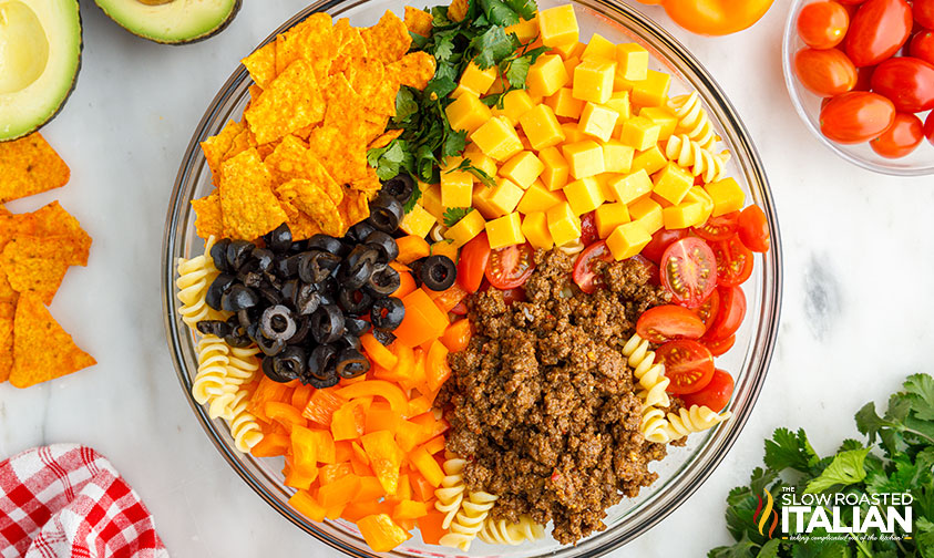 dorito salad ingredients arranged in a bowl