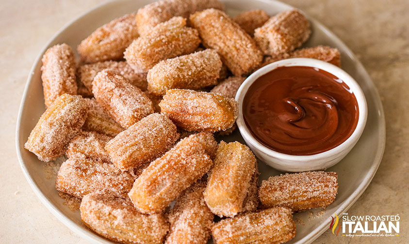 Homemade Churros Recipe on a tray with sauce