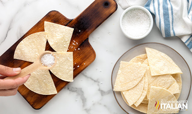 adding salt to homemade nacho chips