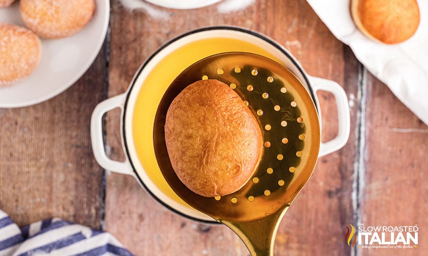 deep fried italian donut on strainer