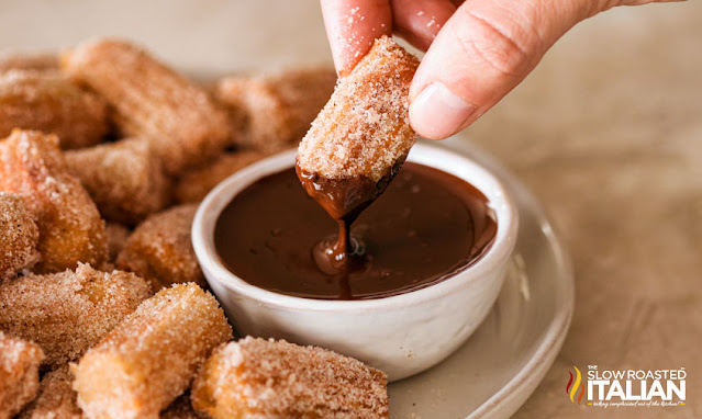 dipping churro bites in chocolate sauce