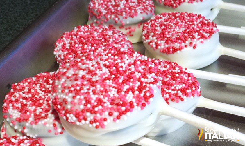 cookie pop covered in red white and pink sprinkles