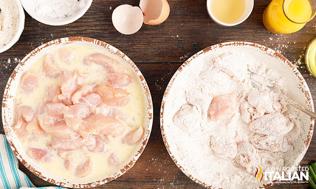 dredging chicken pieces in flour for orange chicken recipe