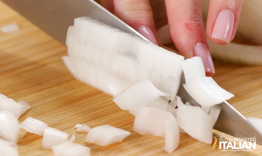 close up: chef\'s knife dicing white onion
