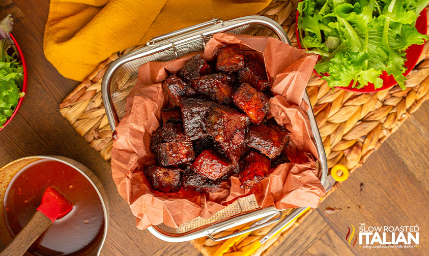 crispy pieces of smoked beef in basket on serving tray