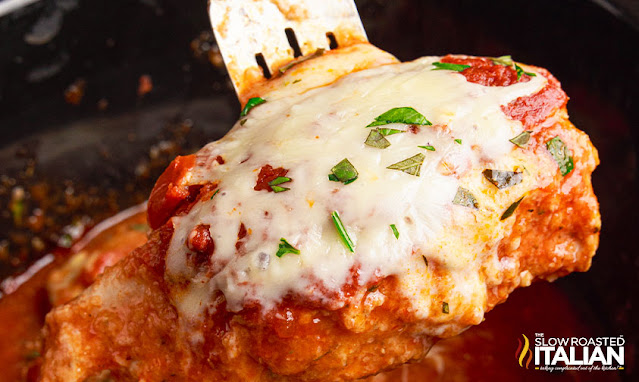 cheesy italian dinner on spatula over a slow cooker