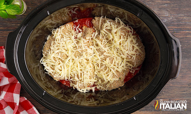 shredded mozzarella cheese on chicken in crockpot