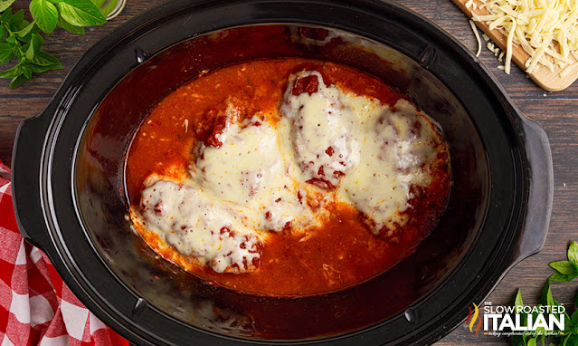 melted cheese on breaded chicken in slow cooker