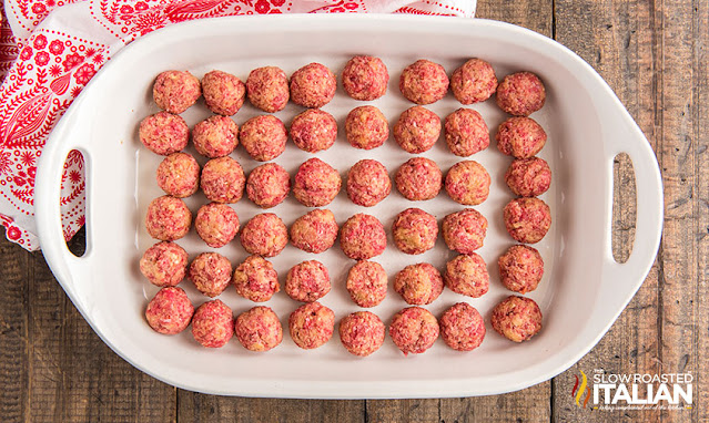 overhead: uncooked cocktail meatballs in white baking dish