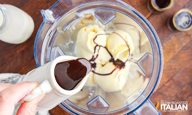 pouring chocolate syrup into blender