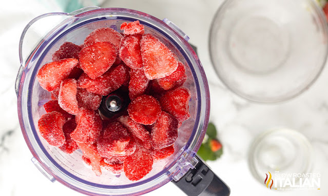 frozen strawberries in bowl of food processor