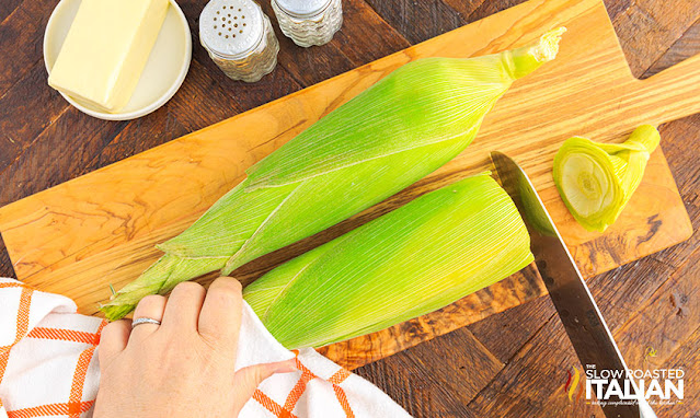 trimming ends from ears of microwave corn in husk
