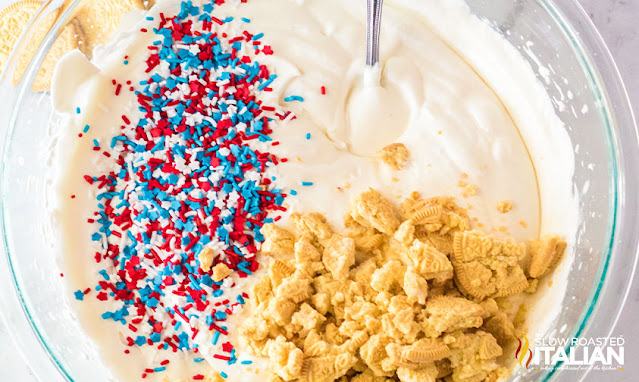 combining cookies, red white and blue sprinkles and condensed milk for patriotic dessert recipe