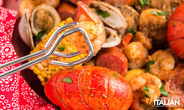 using tongs to serve fresh boiled lobster tail