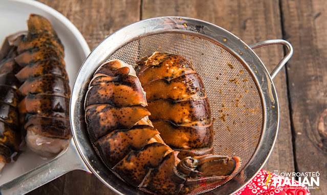 lobster tail in strainer for seafood boil