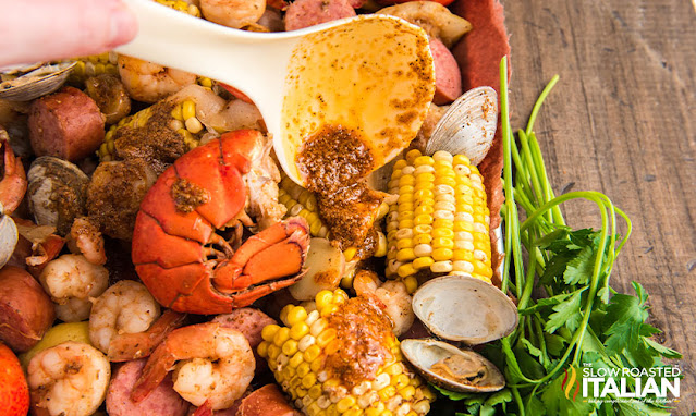 ladling seafood boil from stock pot
