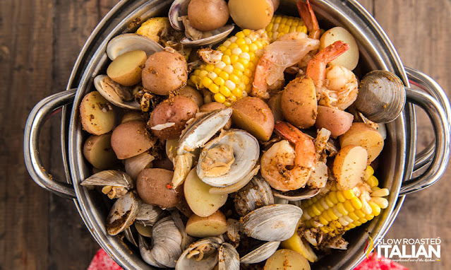 overhead: pot of cooked shellfish with corn and potatoes
