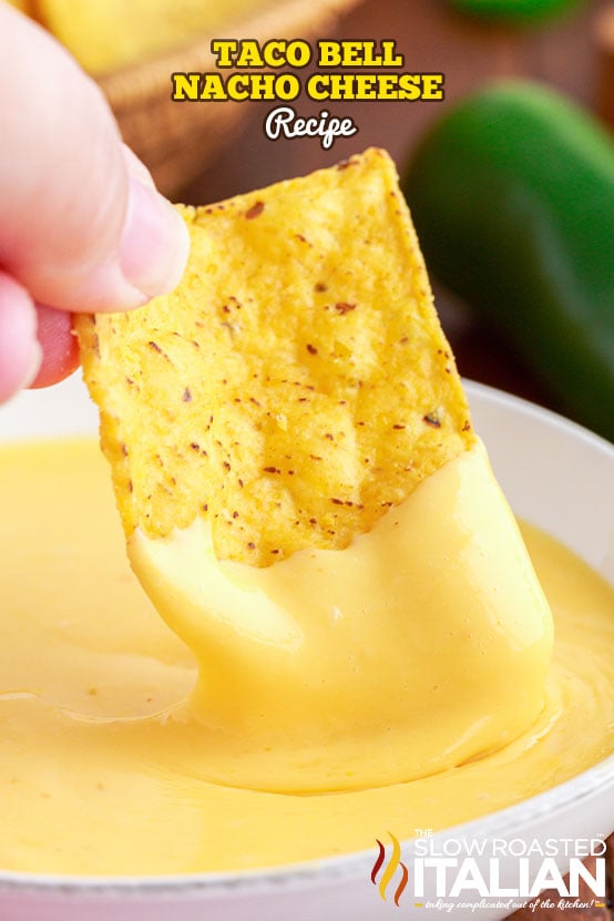 tortilla chip dipped into taco bell nacho cheese sauce