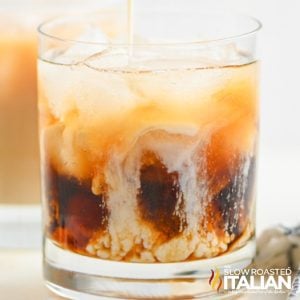 adding milk to white Russian cocktail
