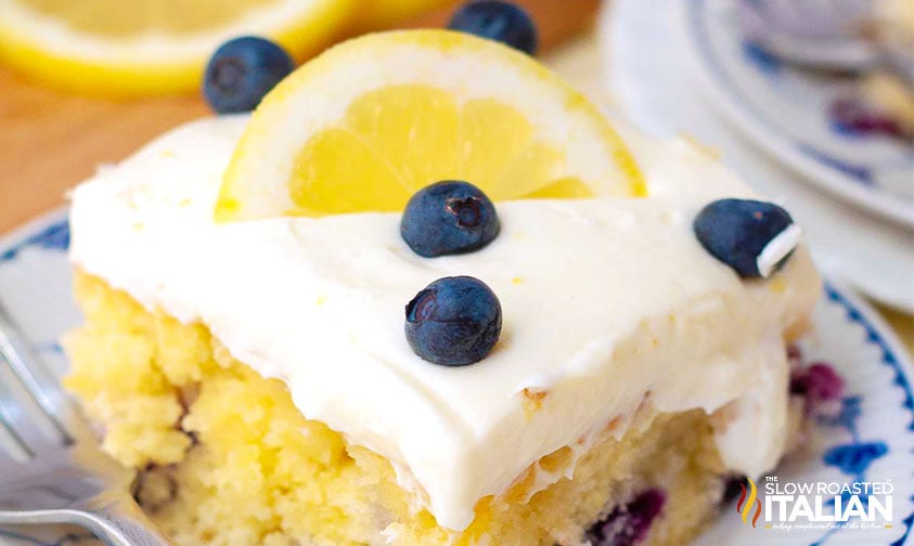 slice of frosted blueberry lemon cake, close up