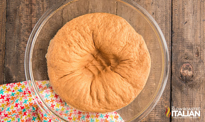 dough rising in glass bowl