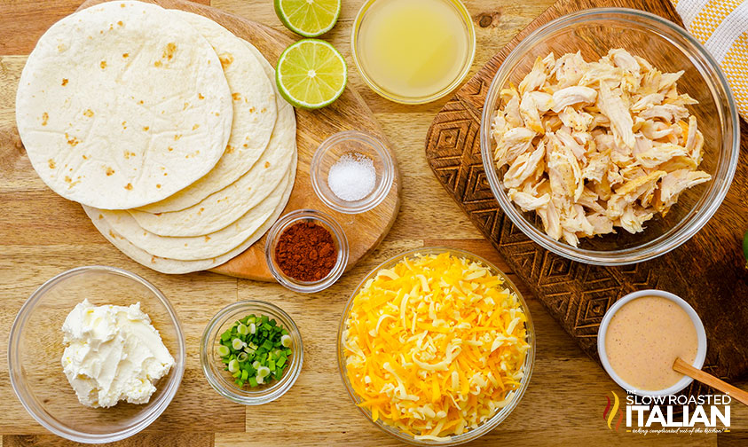 overhead shredded chicken taquitos recipe ingredients in bowls on counter