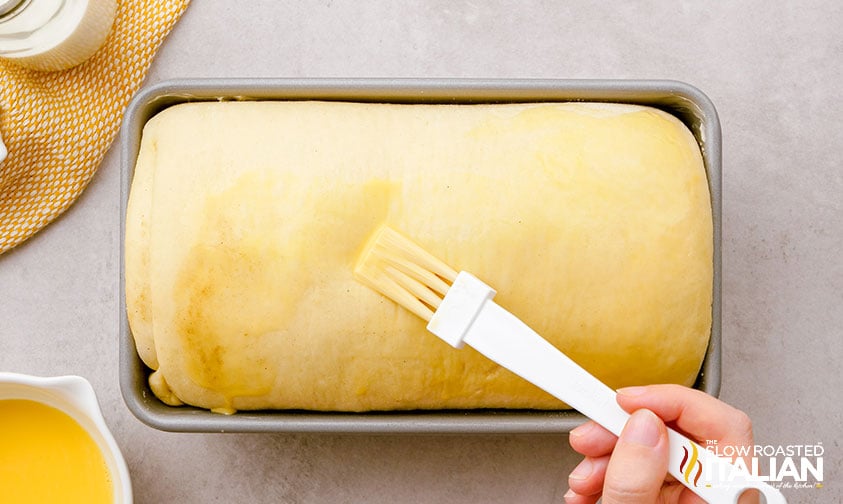 brushing butter on top of yeast bread before baking