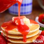 pouring homemade pancake syrup over stack of pancakes