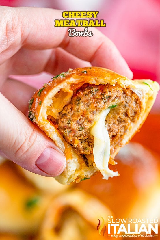 woman's hand holds a cheesy meatball bomb