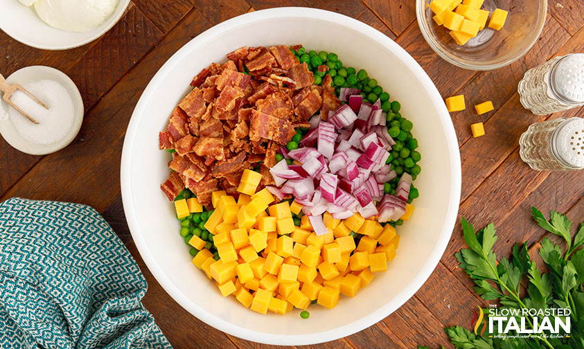 overhead: bowl of diced bacon, cheese, onion and peas