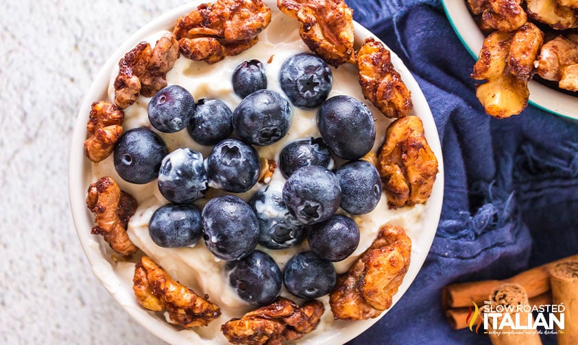 bowl of yogurt with blueberries and maple candied walnuts