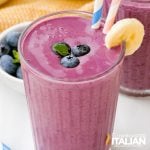 fruit smoothie in glass with blueberries and bananas