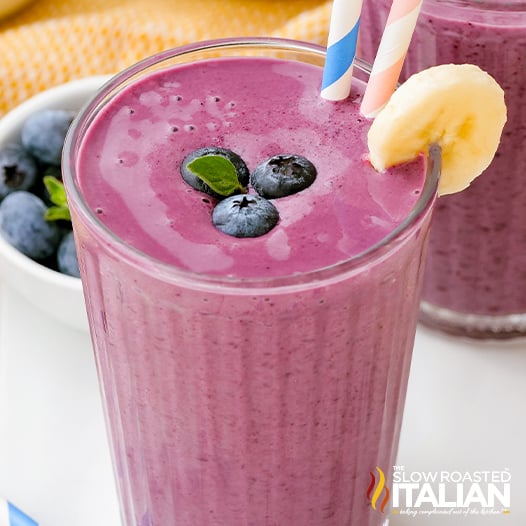 fruit smoothie in glass with blueberries and bananas