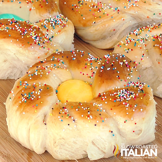 italian easter bread with yellow dyed egg in center