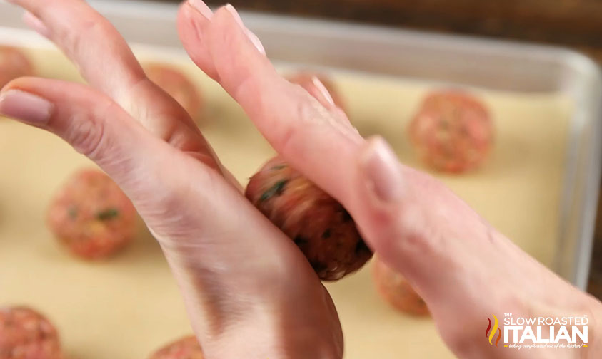 rolling meatball mixture between hands
