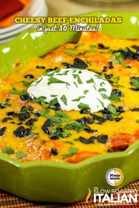 titled (shown in green casserole dish) cheesy beef and bean enchiladas