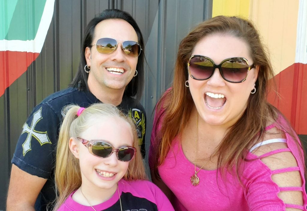 mom dad and daughter, all wearing sunglasses