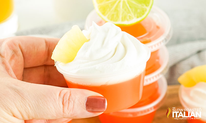 woman's hand holding a bahama mama jello shot