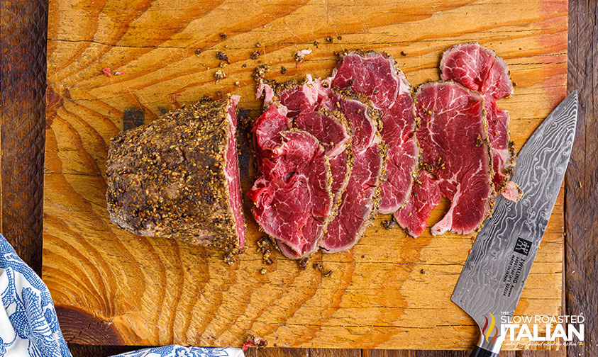fresh sliced beef carpaccio on cutting board