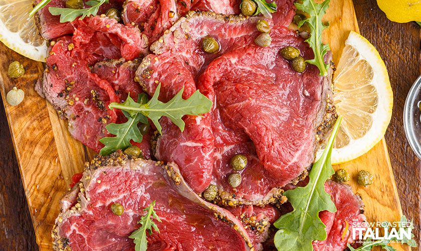 beef carpaccio sliced on wood board