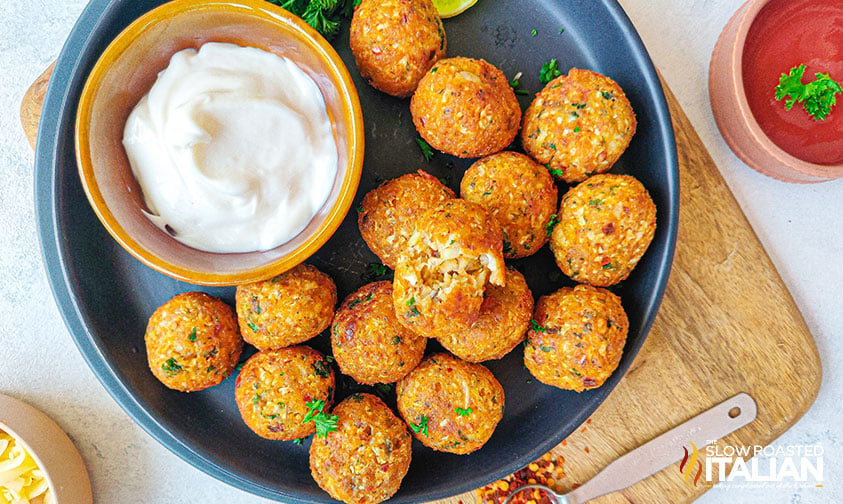 cheesy cauliflower bites on plate with dipping sauce