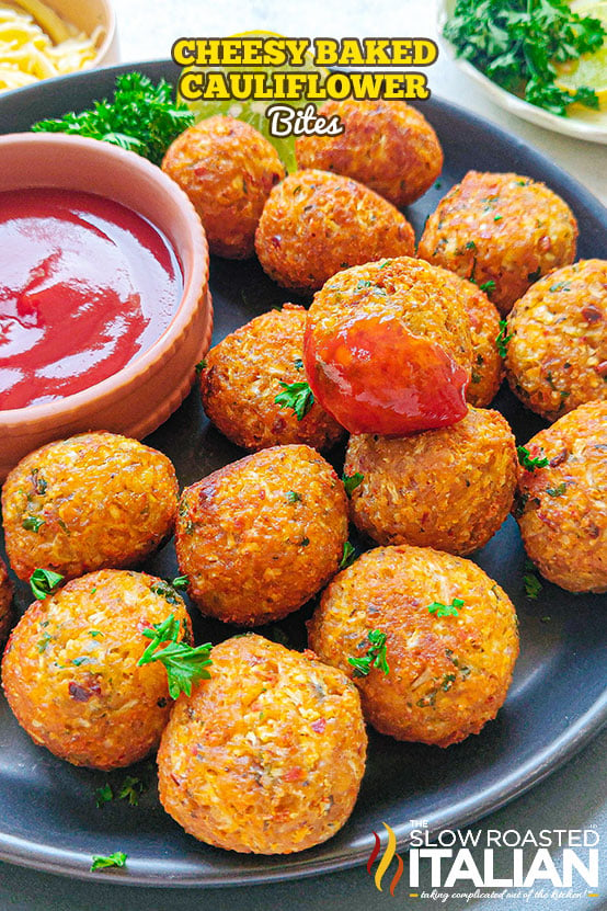 cheesy baked cauliflower bites on plate with marinara for dipping